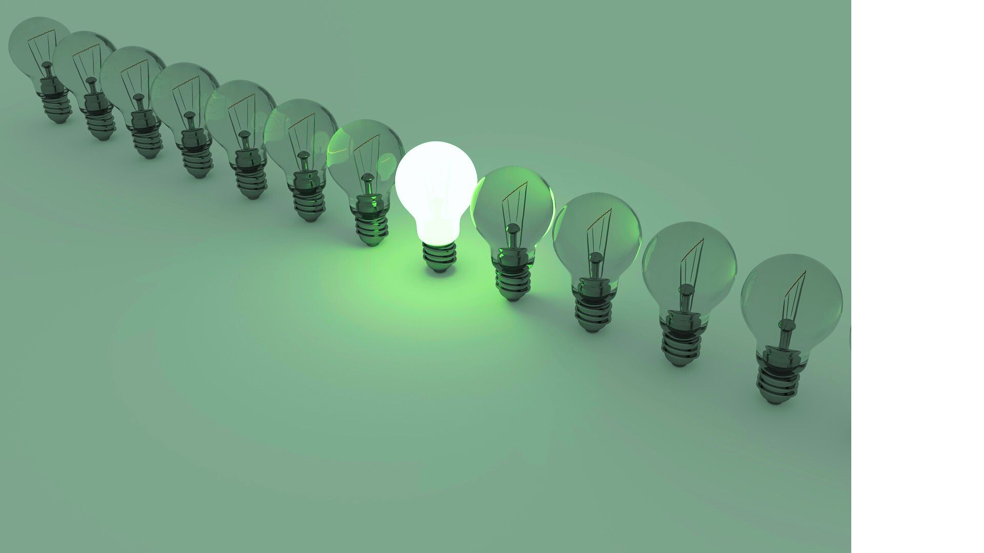 A line of lightbulbs with one glowing green