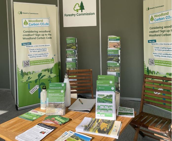 A photo with Woodland Carbon Code banners and leaflets